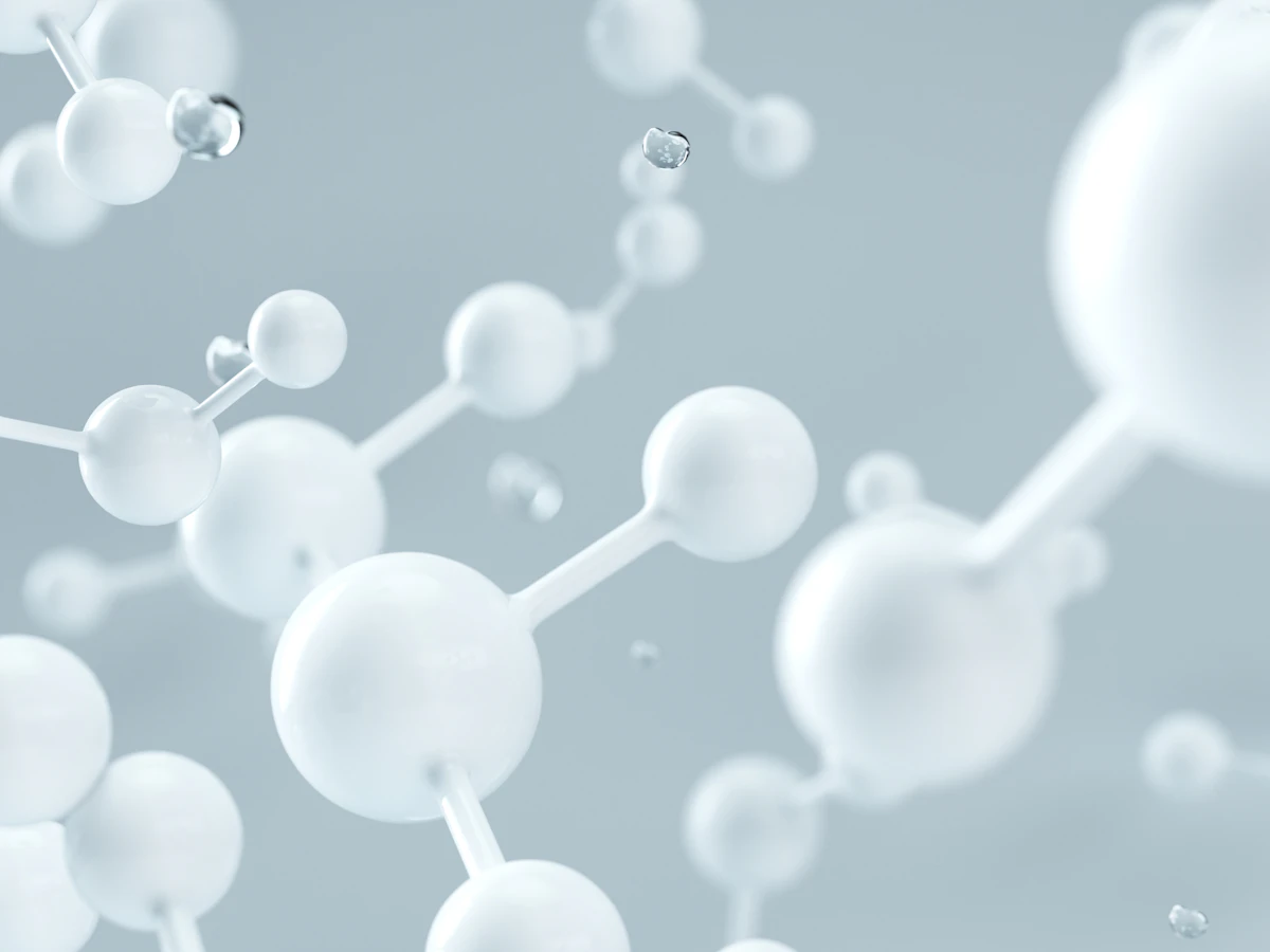 A white molecular model against a pale grey ground